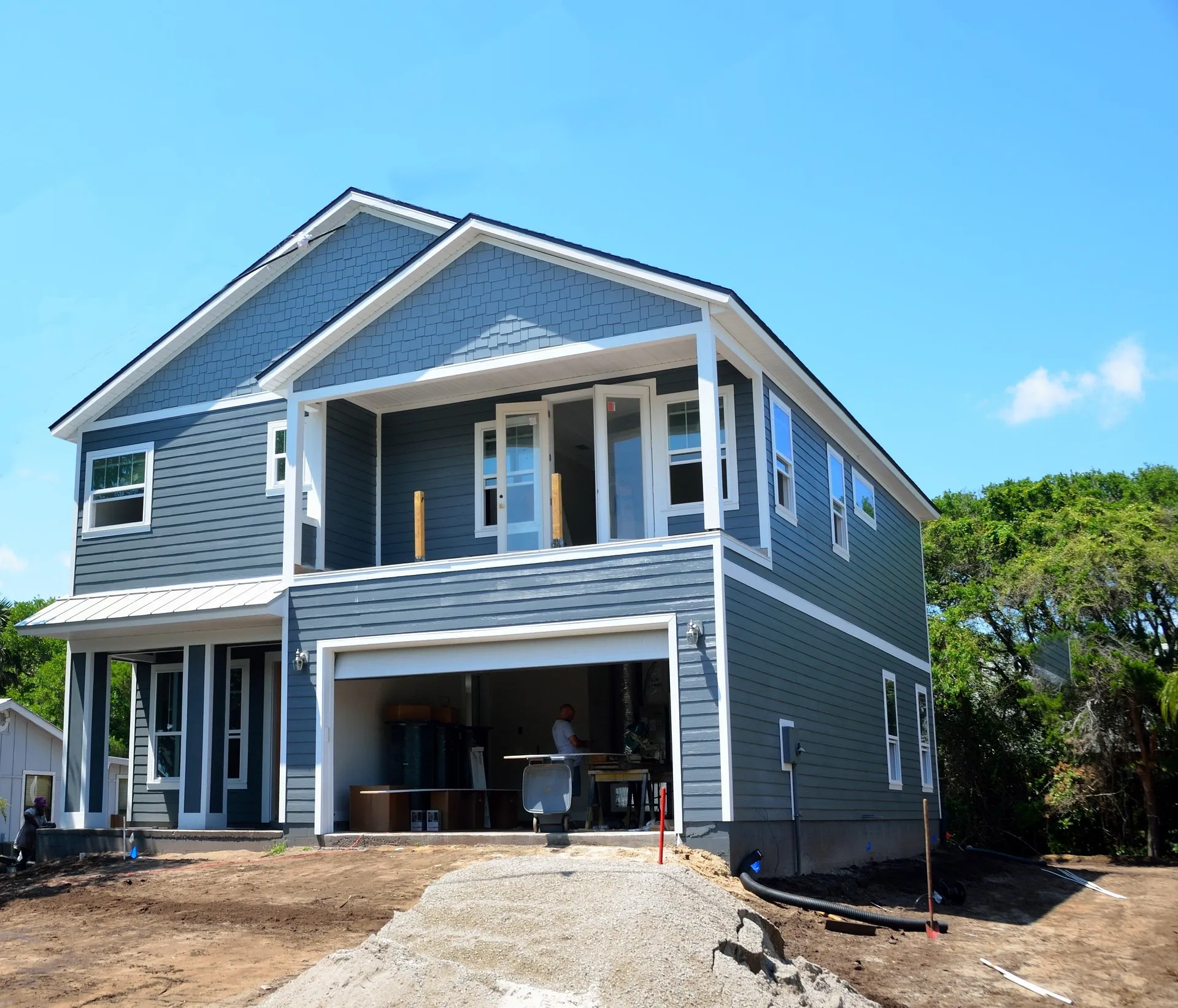 Newly constructed modern two-story home with a garage, showcasing residential construction progress